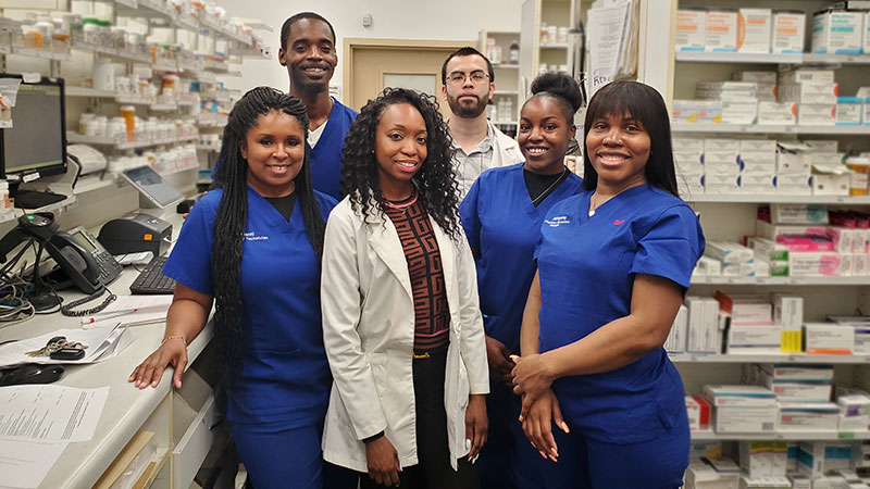 Cameau (in the white coat), and her pharmacy team.