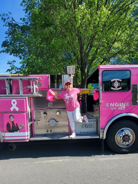 person standing in front of pink truck